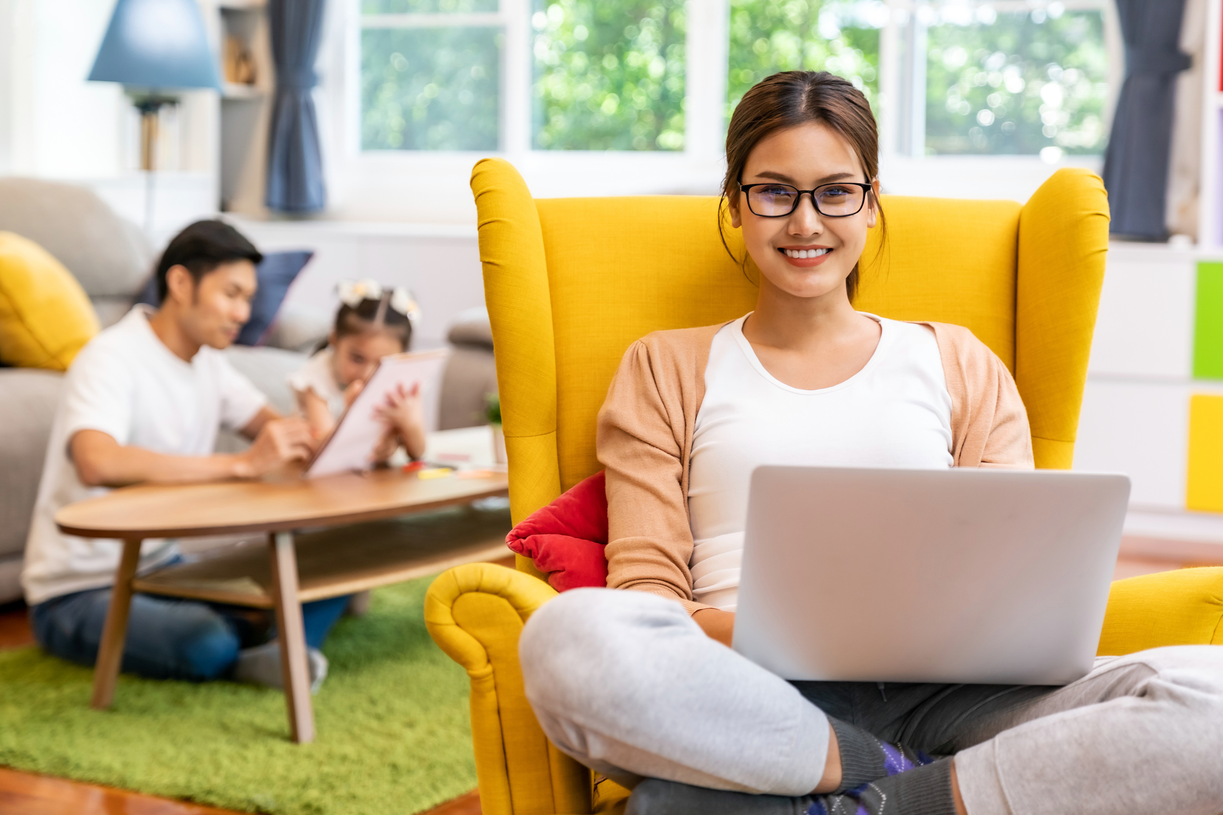 Asian working mom work from home in living room